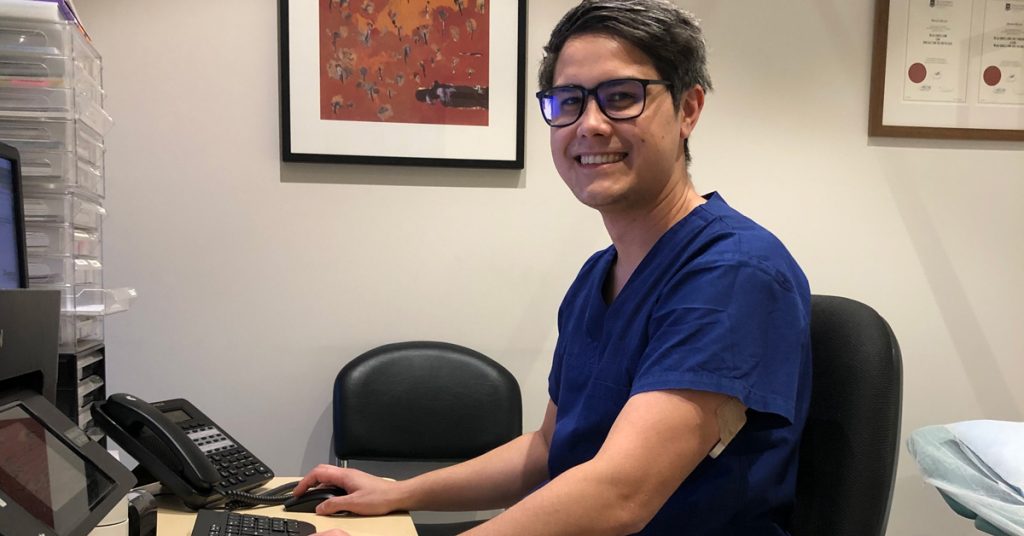 Dr Martin Huynh sitting at desk